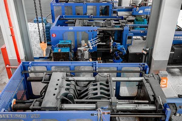 A row of automatic injection molding machines